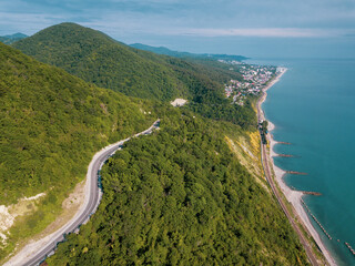 Fototapeta na wymiar Mountain winding zig zag road. Top aerial view: cars driving on road from above.