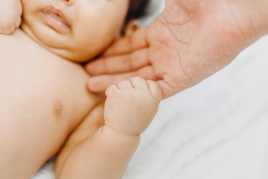 Baby feet in mother hands. Mom and her Child. Happy Family concept. Beautiful conceptual image of Maternity with film grain effect