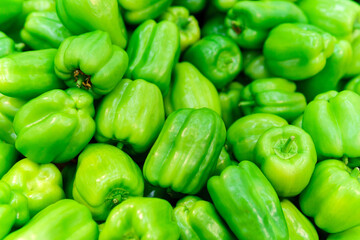 Obraz na płótnie Canvas organic green bell peppers top view, natural background