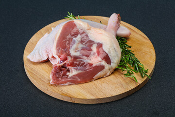 Raw duck leg served rosemary