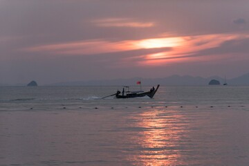 Thai boats on Andaman Sea at sunset in Krabi Thailand Asia