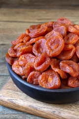 Dried apricots on rustic wooden background 