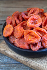 Dried apricots on rustic wooden background 