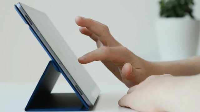 Video of teenager hands working with tablet at homeschooling time during quarantine