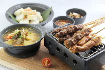 Satay iconic asia cuisine served with meat soup and condiments