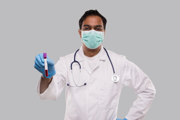 Indian Man Doctor Holding Blood Tube Analysis Wearing Medical Mask And Gloves. Science, Medical Concept. Isolated.