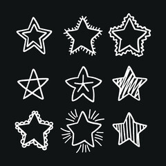 Set of black hand drawn doodle stars in isolated on white background.