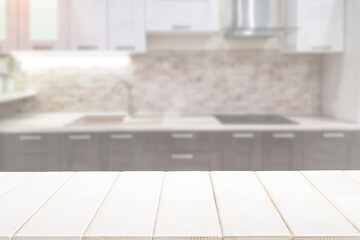 Blurred kitchen interior and white wooden table background. Mock up for display or montage product.