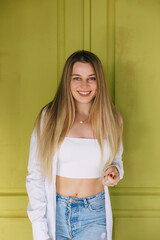 Smiley fitness girl wearing in blue jeans and white top. Casual