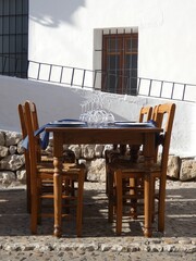 Table set with wine glasses, blue tablecloth outside a restaurant, Altea, Costa Blanca, Spain