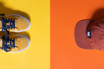 mock up, mustard colored sneakers on yellow and orange background, copy space