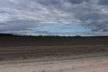 Gloomy steppe landscape. Beautiful cloudy sky over the field.