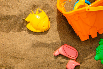 Fototapeta na wymiar Children's plastic beach toys on sand in summer