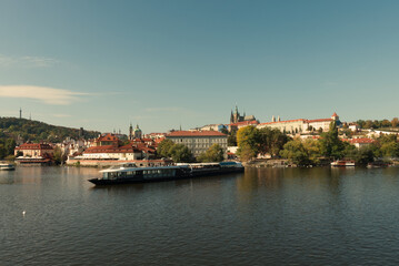 Fototapeta na wymiar Pleasure boat on the Vltava pier in the fall. View of Prague.