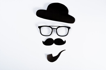 Happy Father Day background concept with paper cut of hat, glasses, black mustache and smoking pipe on white background with copy space for text.