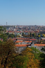 Fototapeta na wymiar View of Prague through the branches of autumn trees.