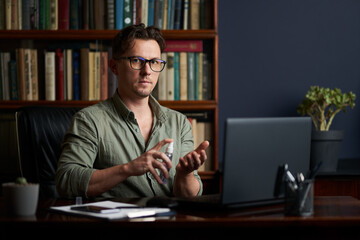 Handsome man working at his workplace. Work from home.