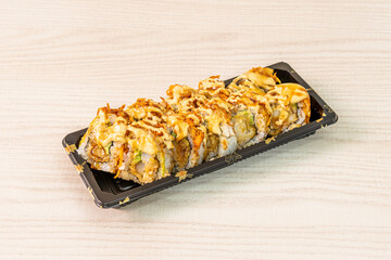 Ration of uramaki on wooden table