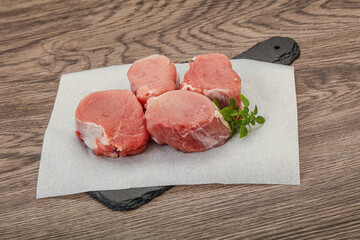 Raw pork medallion served rosemary