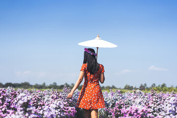 Relax travel adult woman walking in margaret flower outdoor on summer