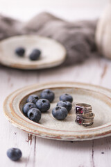 Silver ring on a plate. Blueberries. 