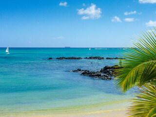 Fototapeta na wymiar Turquoise beach view on the Indian Ocean in Grand Baie, Mauritius Island
