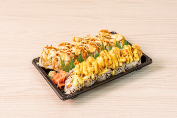 Ration of uramaki on wooden table