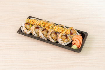 Ration of uramaki on wooden table