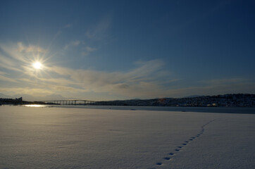 tromsoe city island in snowy winter sun in early morning