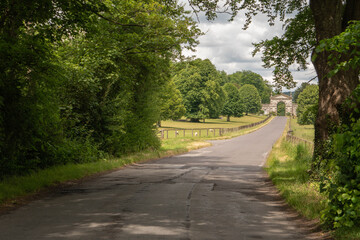 Obraz premium Long road leading down to the impressive gates of the Fonthill estate in the English countryside situated in Wiltshire, South West England