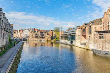 Downtown brick houses, river and moored boat Ghent, Belgium