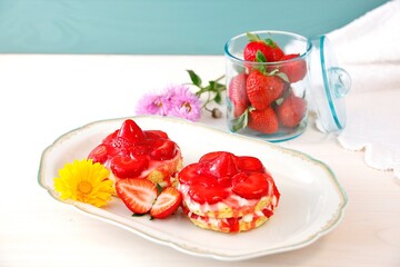 Homemade tasty mini Strawberry and Yogurt cream sponge cake. two small Delicate and delicious biscuit cakes with cream and strawberries. Beautiful birthday cake on table