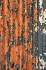 Old worn rusty corrugated steel texture on exterior wall.