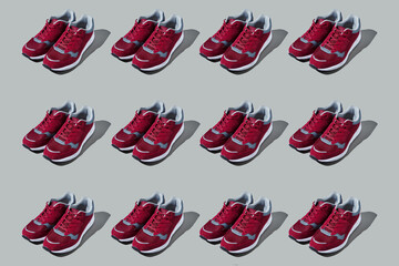 Colourful pattern of sneakers on grey background. View from top.