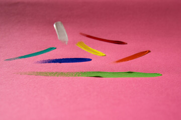 red, blue, yellow, orange and light blue paint splashes with pink background