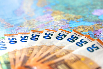 Euro bills on a world map close-up