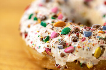 Close-up of a donut with icing and colored chocolate powder
