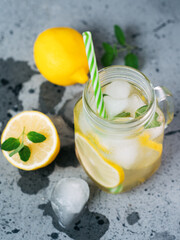 summer refreshing lemonade with lemon and mint or Mojito in a jar. Iced summer drink