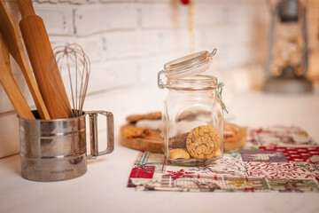 Cookies with chocolate and cinnamon in a glass jar, standing on kitchen.