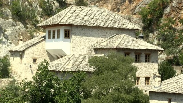 Blagaj Tekija house in cave near river. Blagaj is a popular destination in Bosnia. Old Muslim religious school built at Buna river.