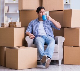 Young man moving in to new house with boxes