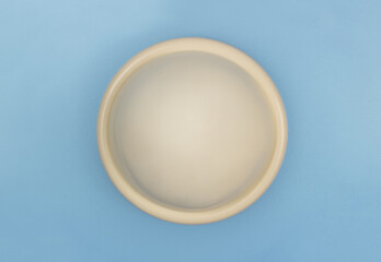 a diaphragm, a non-hormonal, barrier method of female contraception inserted in the vagina before sex, on a blue background