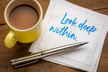 look deep within inspirational and spiritual handwriting on a napkin with a cup of coffee