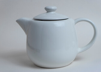 white teapot on a white background
