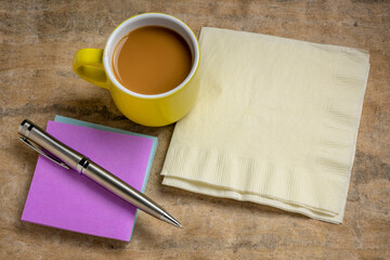 reminder note and napkin abstract, office or coffee break concept