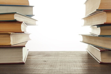 stack of old books on a wooden table with copy space