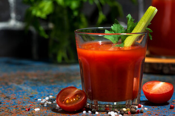 healthy tomato juice with salt and celery, closeup