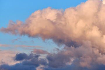Evening sky with beautiful vanilla and blue clouds.