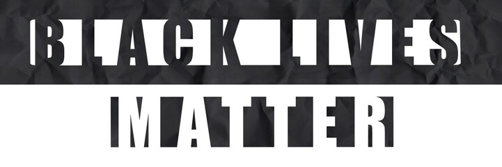 Black Lives Matter die-cut style letters on a crumpled black and white paper