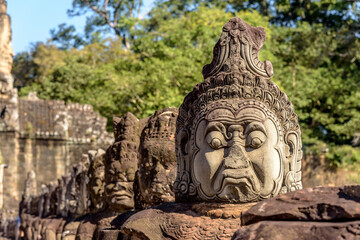 Obraz premium Stone Statue at the South Bayon Gate to Bayon Temple at the Angkor Wat Complex Near Siem Reap Cambodia